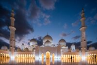 white mosque under cloudy sky