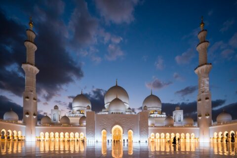 white mosque under cloudy sky